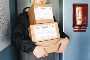Picture of deliveryman holding packages to be delviered to a home.